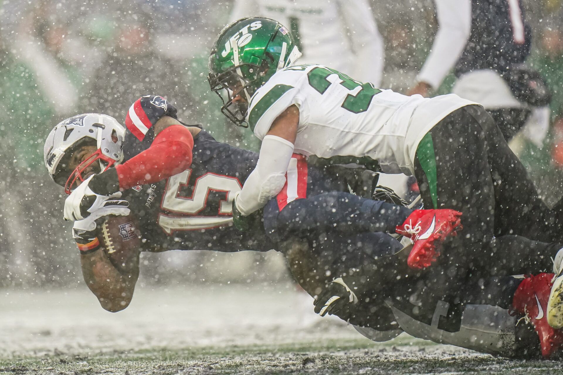 New England Patriots RB Ezekiel Elliott (15) reaches for extra yardage against the New York Jets.