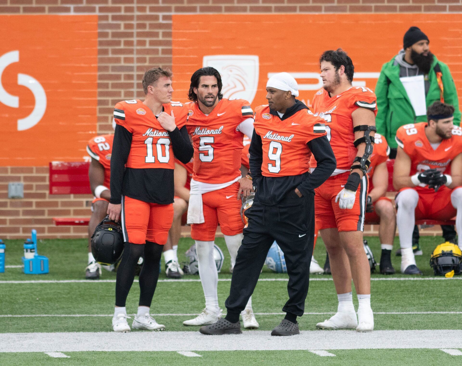 Former Oregon QB Bo Nix (10), Notre Dame QB SamHartman, and Washington QB Michael Penix Jr.(9) chat along the sideline during the Reese's Senior Bowl in Mobile, Alabama on Saturday, Feb. 3, 2024.