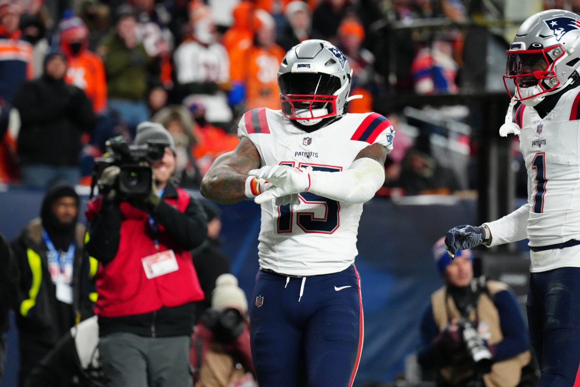 New England Patriots RB Ezekiel Elliott (15) celebrates a touchdown against the Denver Broncos.