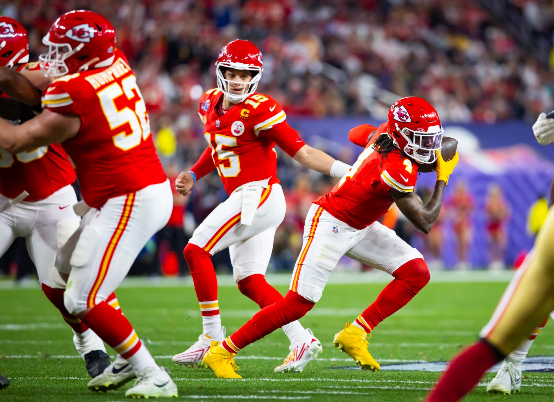 Kansas City Chiefs quarterback Patrick Mahomes (15) hands off the ball to wide receiver Rashee Rice (4) against the San Francisco 49ers during Super Bowl LVIII at Allegiant Stadium.