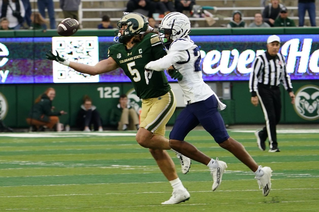 Colorado State Rams tight end Dallin Holker (5) tries in vain to make a catch with Nevada Wolf Pack defensive back Chad Brown (24) holding him at Sonny Lubick Field at Canvas Stadium.