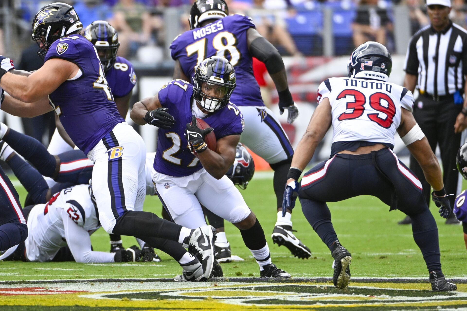 Baltimore Ravens running back J.K. Dobbins (27) carries the ball against the Houston Texans during the first half at M&T Bank Stadium.