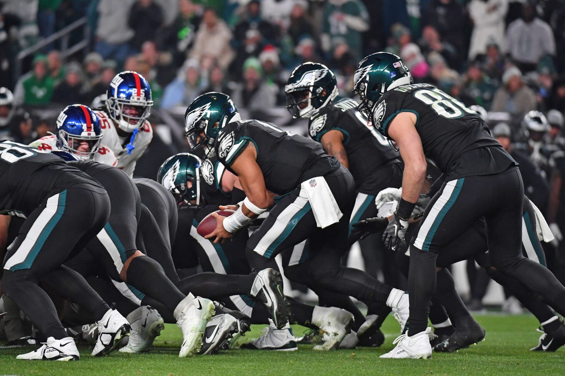 Philadelphia Eagles quarterback Jalen Hurts (1) gets a push from teammates against the New York Giants at Lincoln Financial Field.