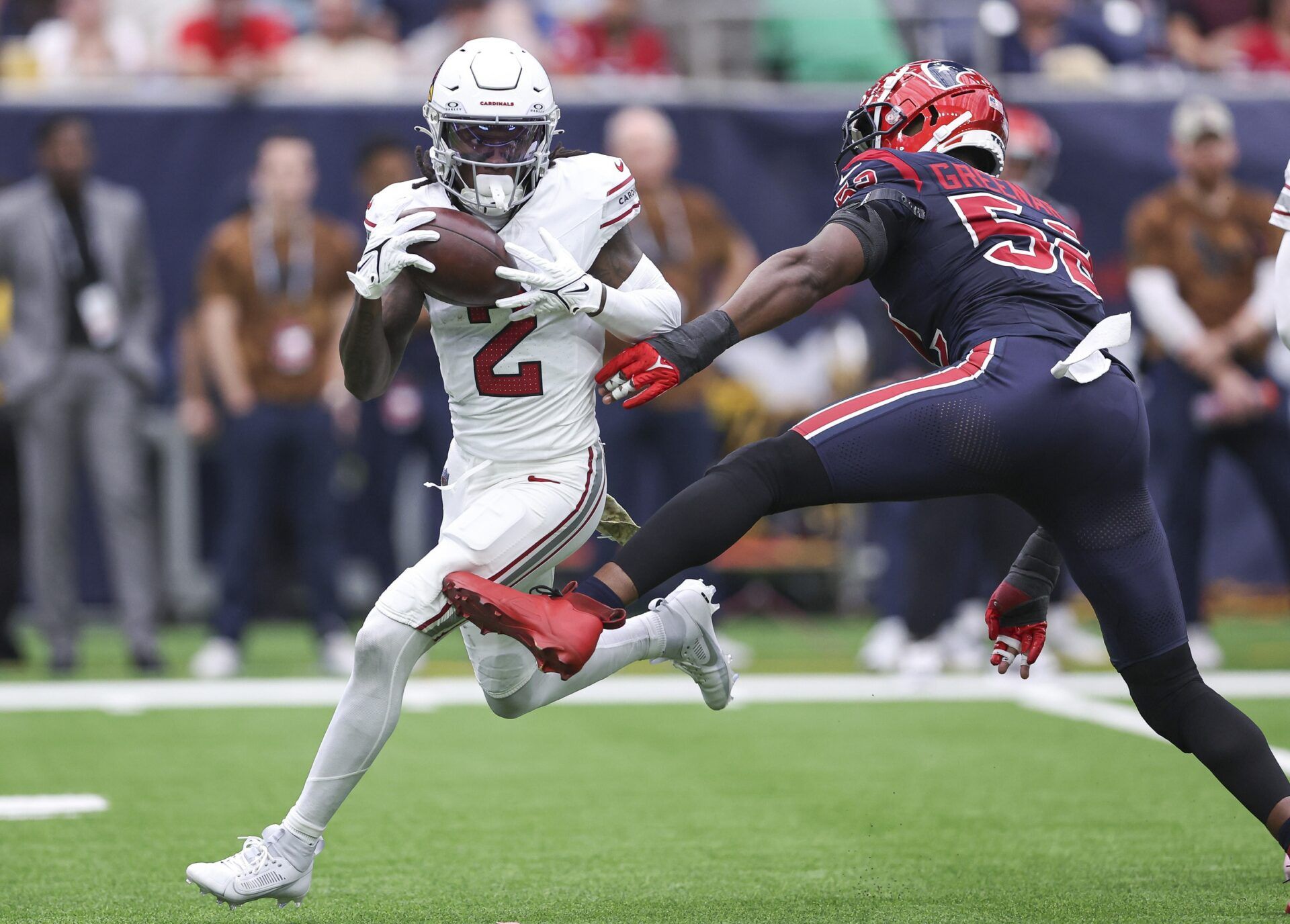 Arizona Cardinals wide receiver Marquise Brown (2) runs with the ball as Houston Texans defensive end Jonathan Greenard (52) attempts to make a tackle during the second quarter at NRG Stadium.