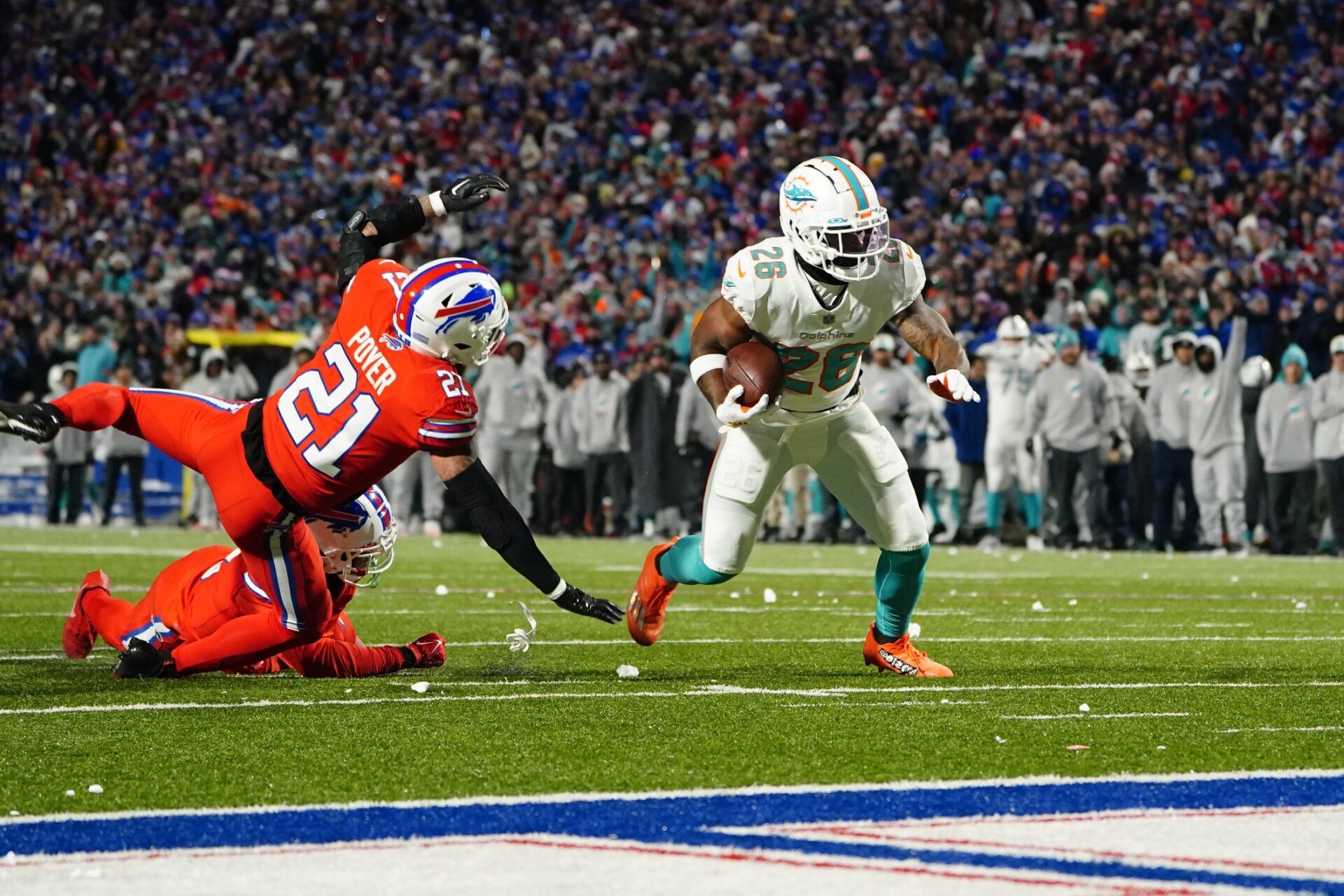 Miami Dolphins running back Salvon Ahmed (26) runs with the ball and breaks a tackle attempt by Buffalo Bills safety Jordan Poyer (21) and scores a touchdown during the first half at Highmark Stadium.