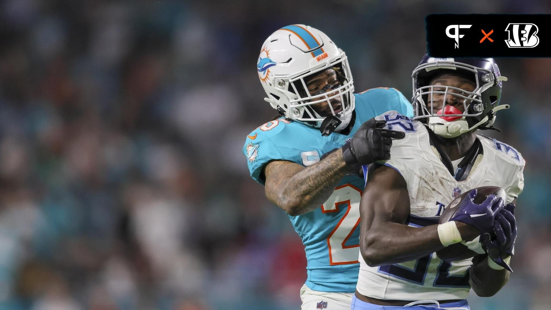 Tennessee Titans running back Tyjae Spears (32) makes a catch ahead of Miami Dolphins cornerback Xavien Howard (25) during the third quarter at Hard Rock Stadium.