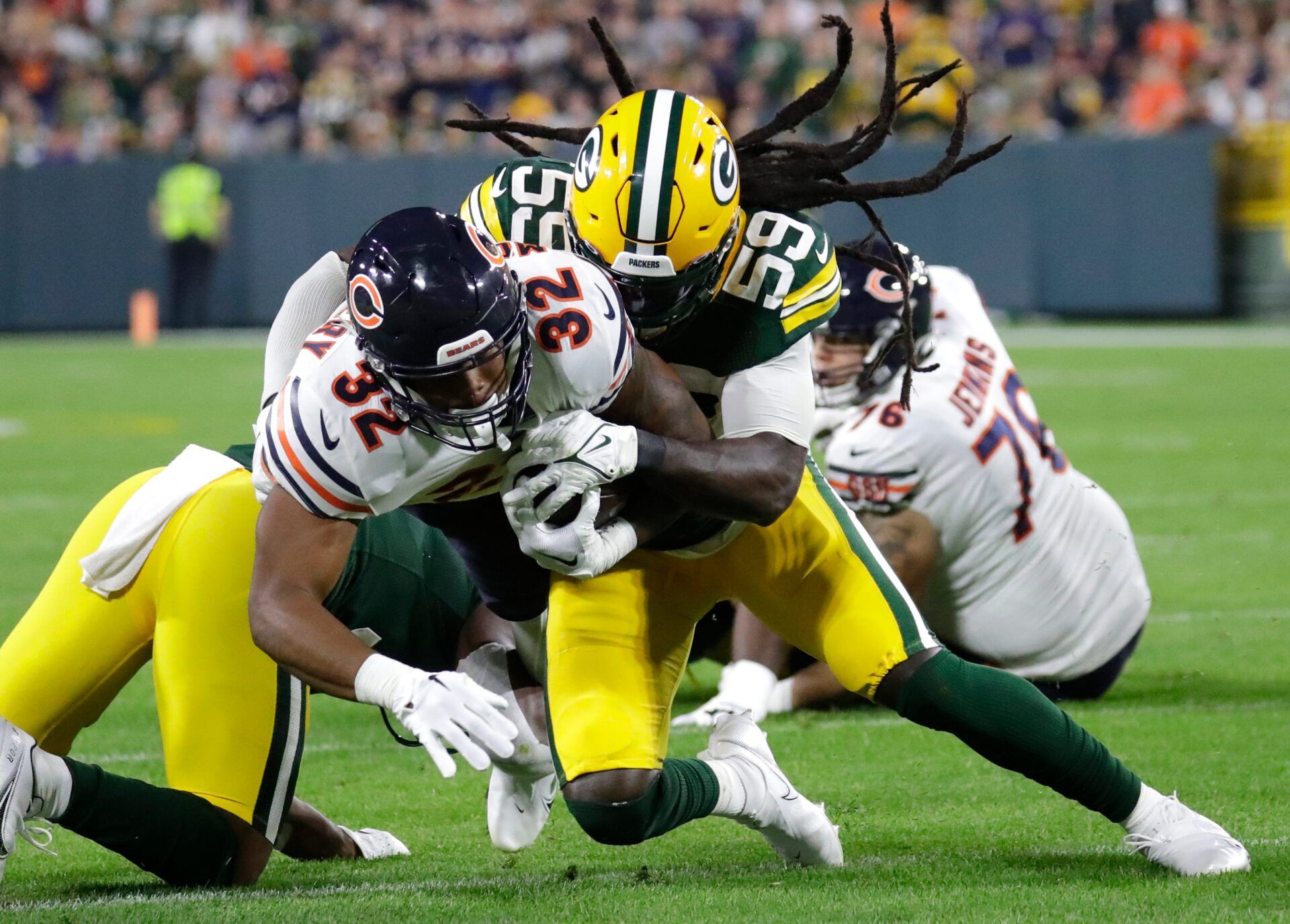 Green Bay Packers linebacker De'Vondre Campbell (59) tackles Chicago Bears running back David Montgomery (32) during their football game Sunday, September 18, 2022, at Lambeau Field in Green Bay, Wis.