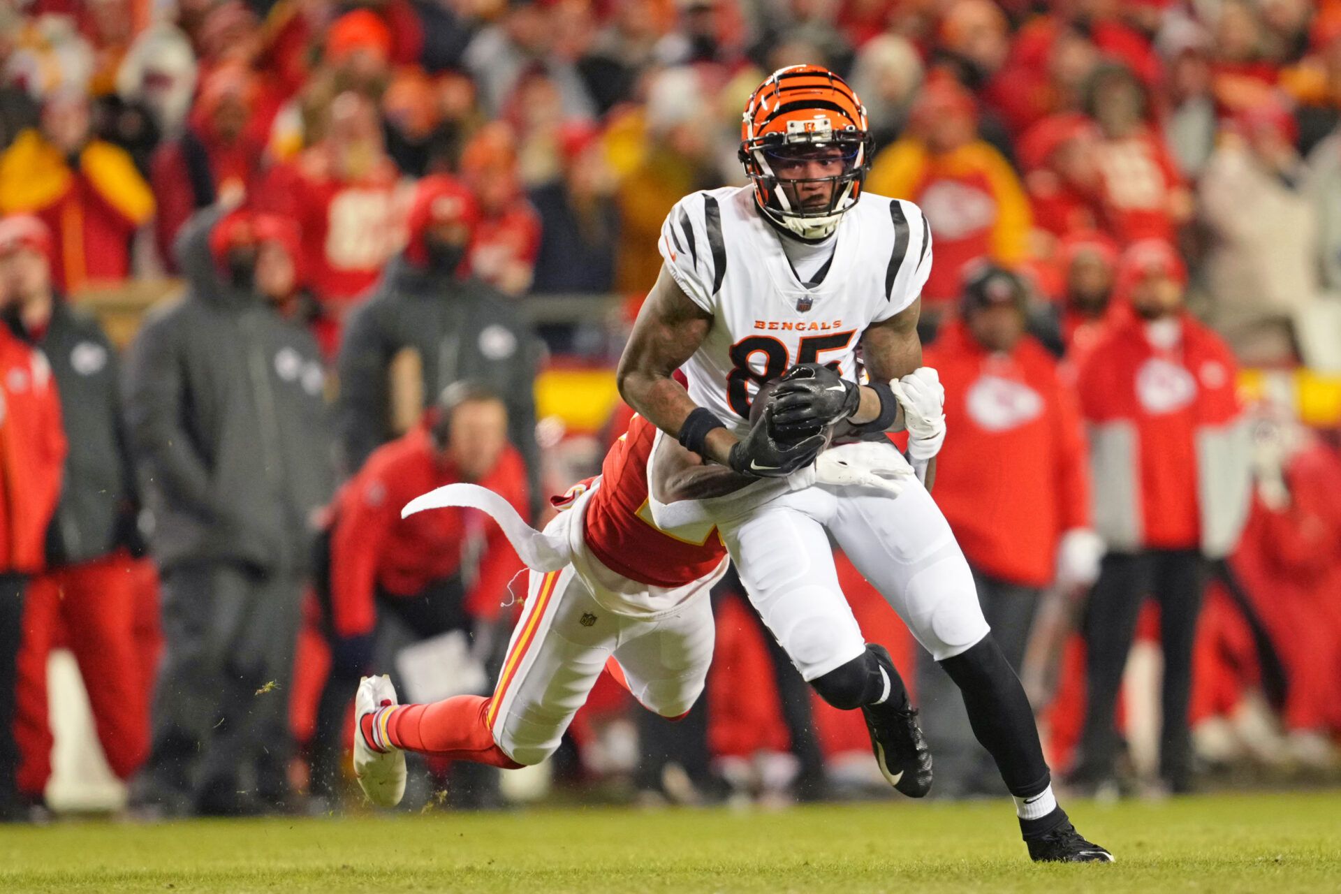 Cincinnati Bengals wide receiver Tee Higgins (85) makes a catch as Kansas City Chiefs cornerback Joshua Williams (23) defends during the second quarter of the AFC Championship game at GEHA Field at Arrowhead Stadium.