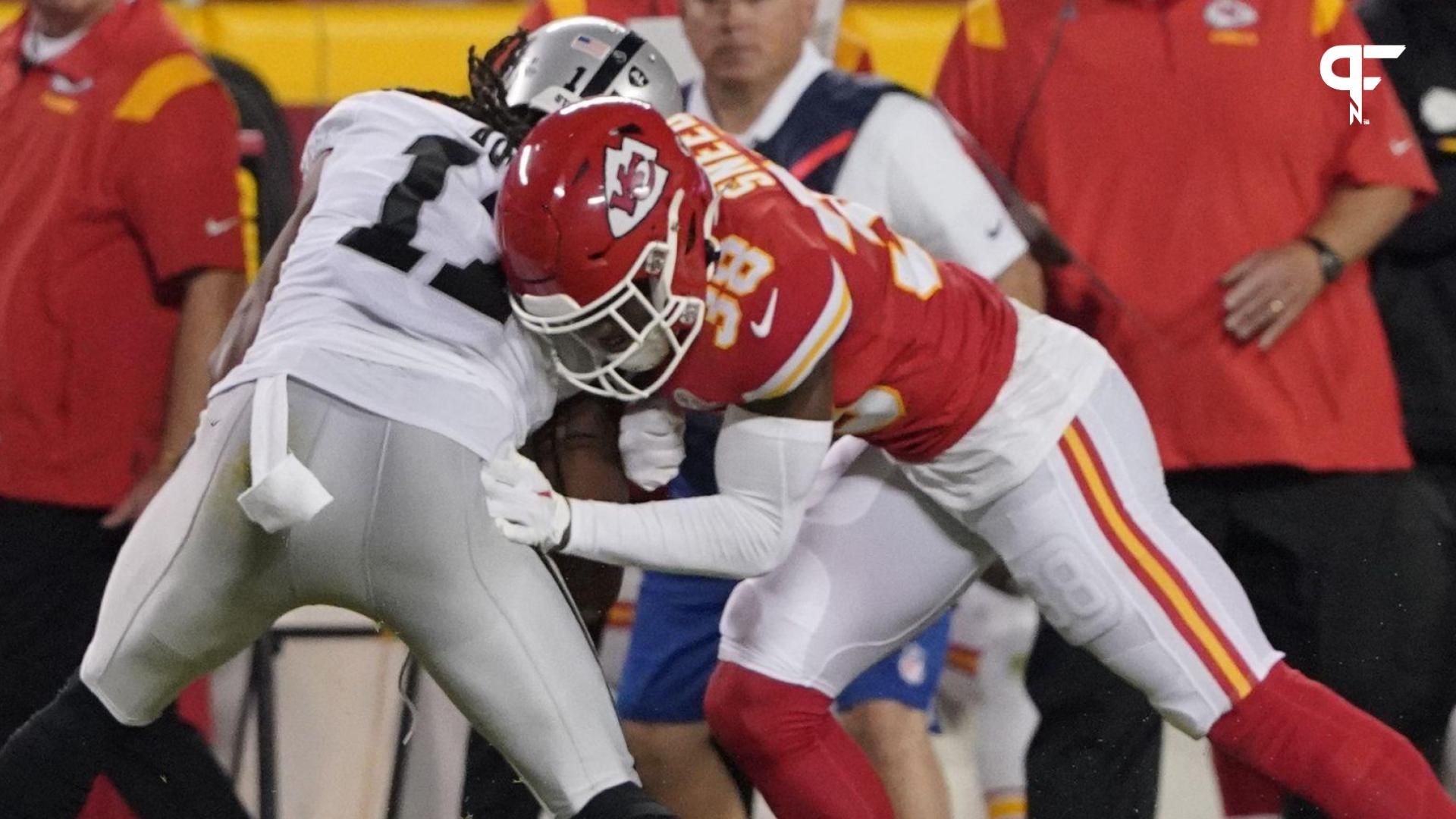 Kansas City Chiefs cornerback L'Jarius Sneed (38) tackles Las Vegas Raiders wide receiver Davante Adams (17) in the second half at GEHA Field at Arrowhead Stadium.