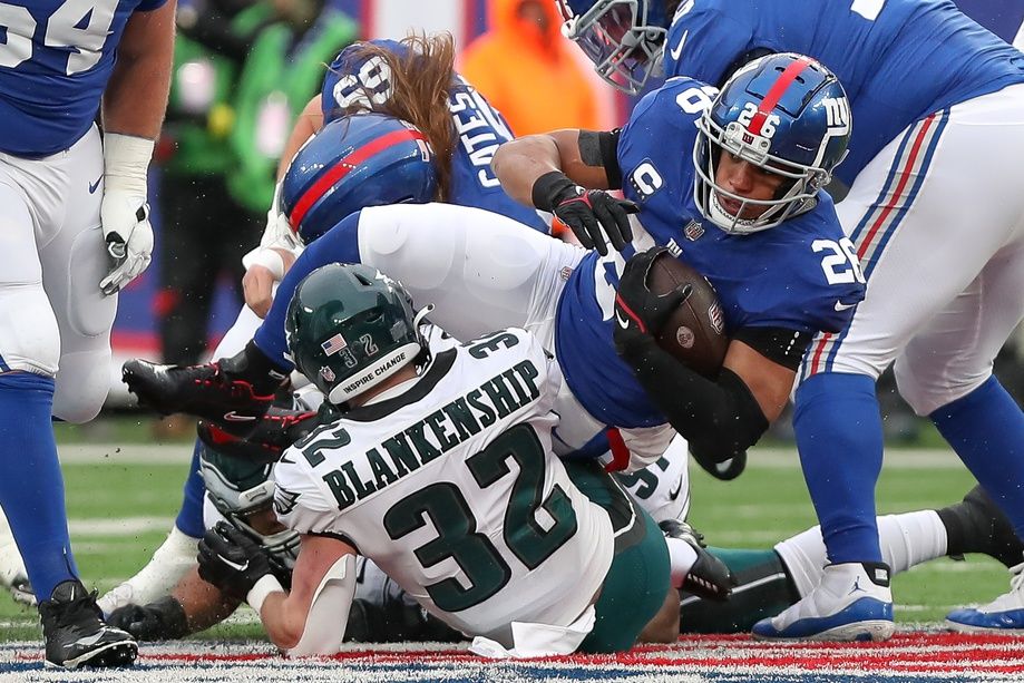 New York Giants running back Saquon Barkley (26) is tackled by Philadelphia Eagles safety Reed Blankenship (32) during the second quarter at MetLife Stadium.