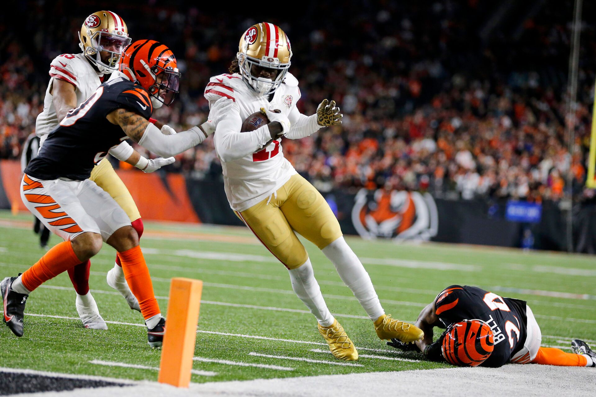 San Francisco 49ers wide receiver Brandon Aiyuk (11) scores the winning touchdown in overtime as Cincinnati Bengals safety Vonn Bell (24) and free safety Jessie Bates (30) attempt the tackle at Paul Brown Stadium.