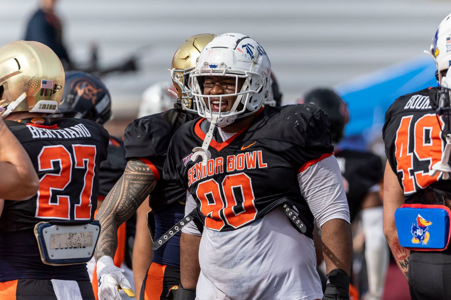 National defensive lineman DeWayne Carter of Duke (90) grins after breaking from a team gathering during practice for the National team at Hancock Whitney Stadium.