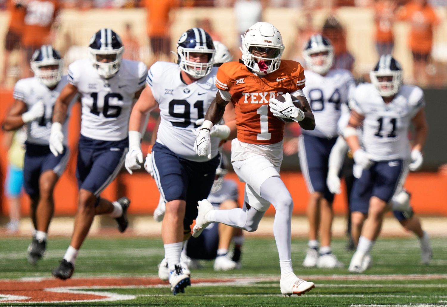 Texas Longhorns WR Xavier Worthy (1) returns a punt for a touchdown against the BYU Cougars.