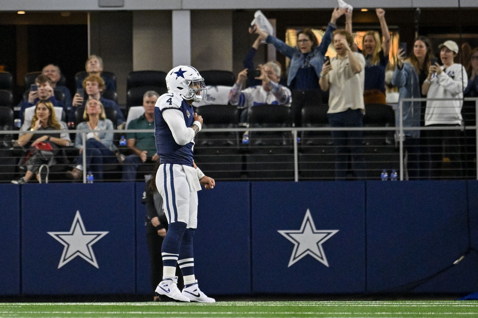 Dallas Cowboys quarterback Dak Prescott (4) celebrates after he throws for a touchdown against the Washington Commanders during the second quarter at AT&T Stadium.