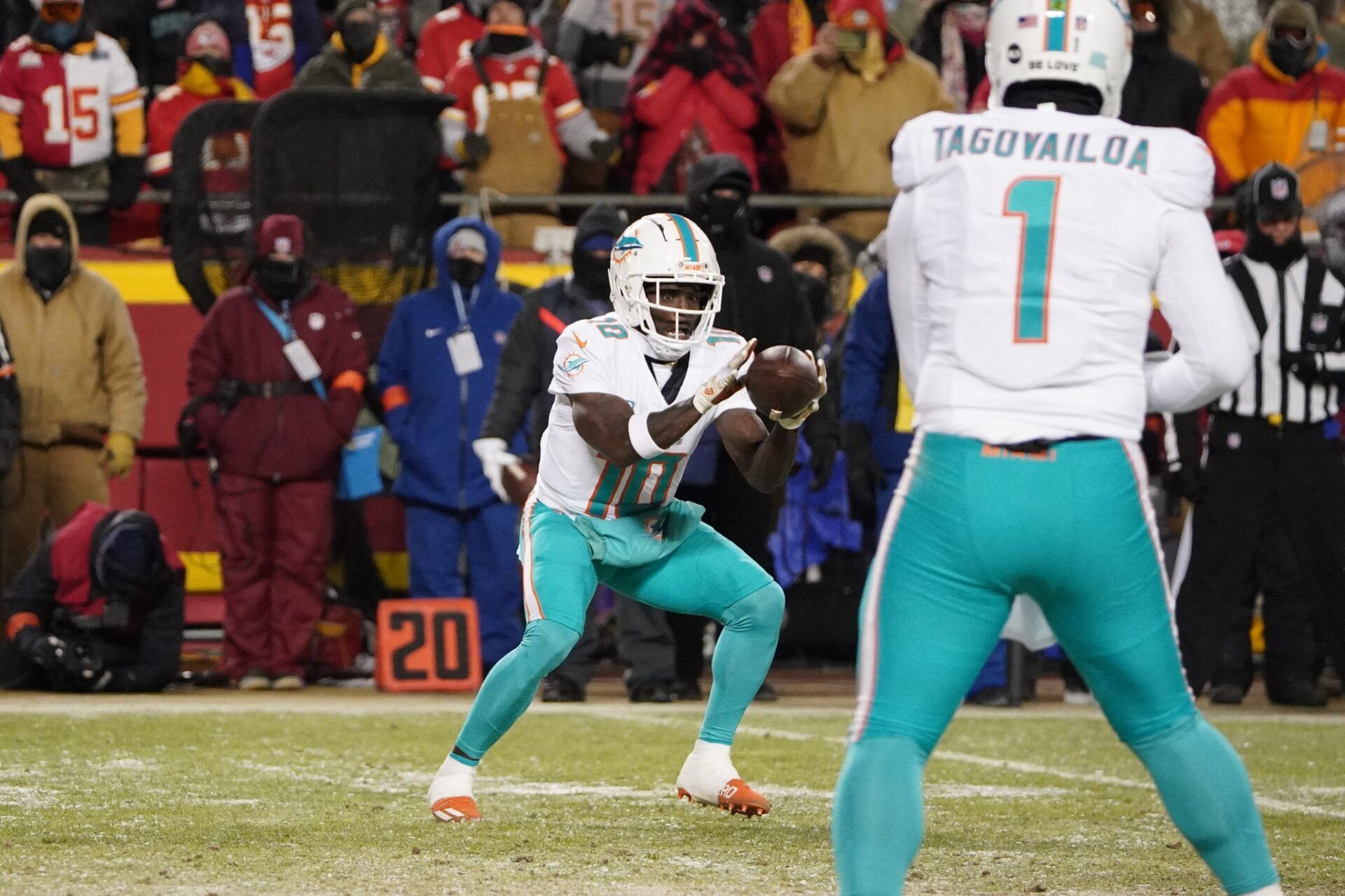 Miami Dolphins wide receiver Tyreek Hill (10) catches a pass from quarterback Tua Tagovailoa (1) during the first half of the 2024 AFC wild card game at GEHA Field at Arrowhead Stadium.