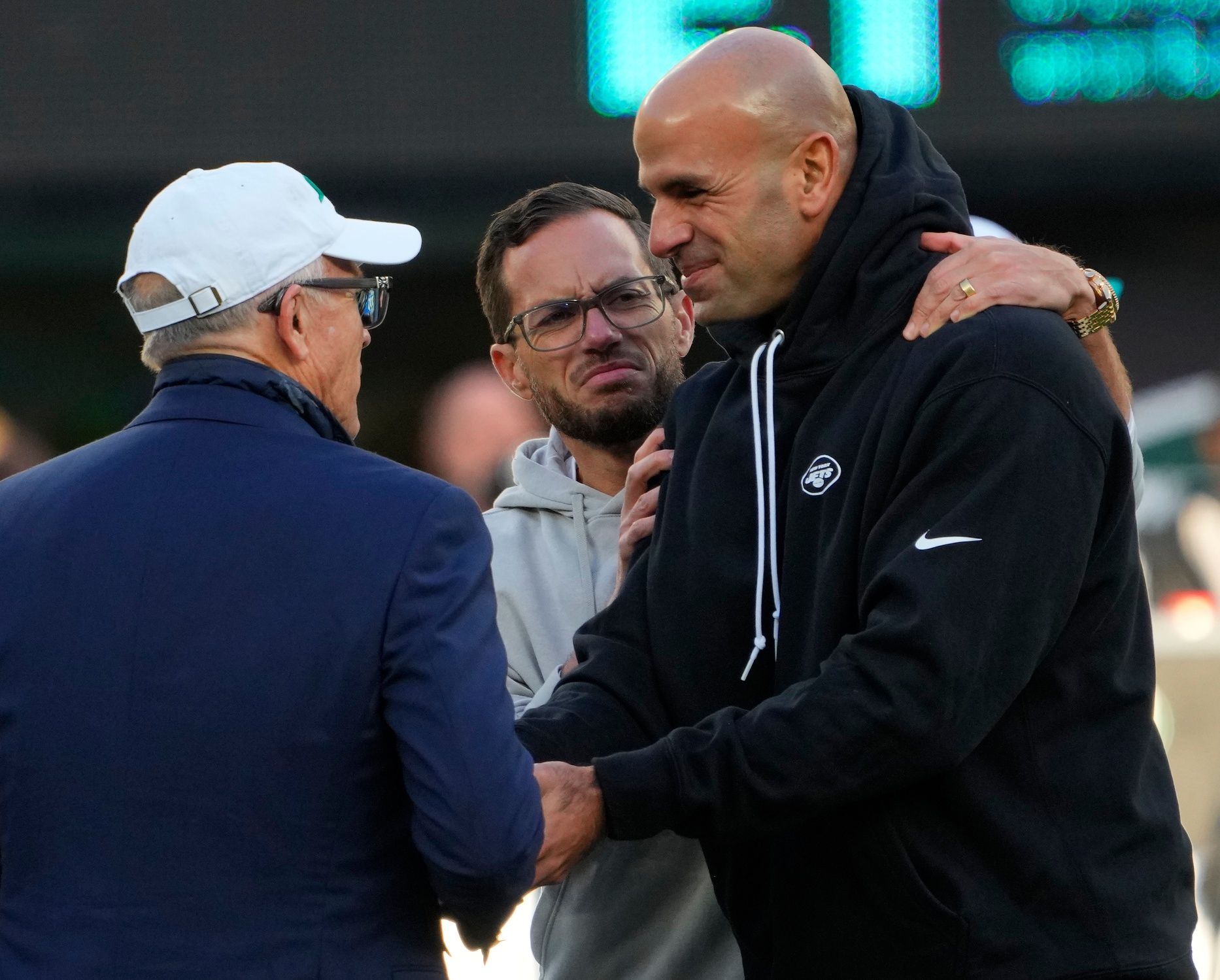 New York Jets owner Woody Johnson, left, talks with Miami Dolphins head coach Mike McDaniel, center, and New York Jets head coach Robert Saleh, right, prior to the game at MetLife Stadium.