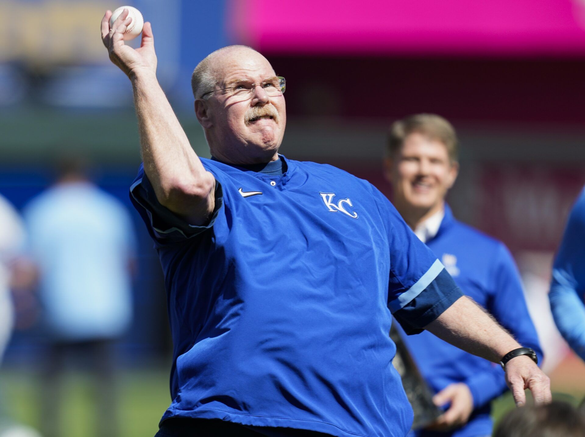 Kansas City Chiefs head coach Andy Reid throws out the first pitch at the Royals' Opening Day game.