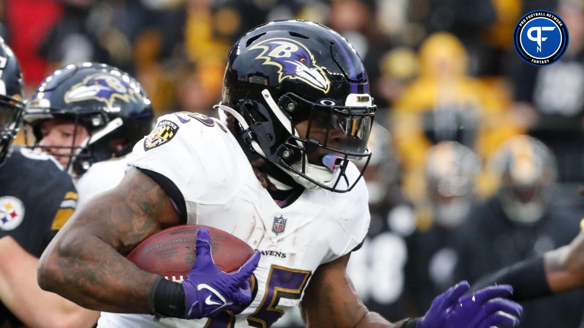 Baltimore Ravens running back Gus Edwards (35) runs the ball against the Pittsburgh Steelers during the fourth quarter at Acrisure Stadium.