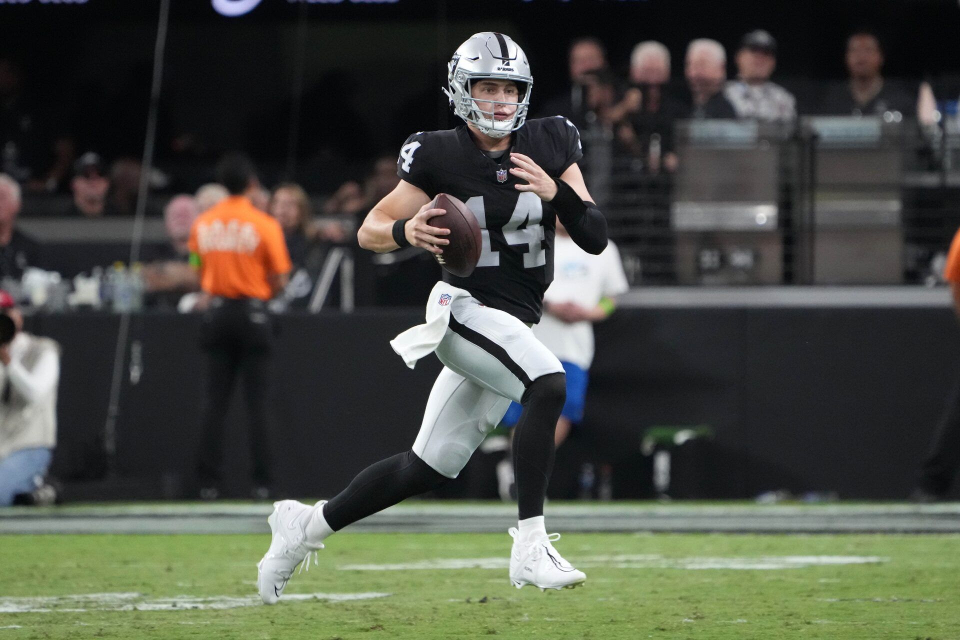 Las Vegas Raiders quarterback Chase Garbers (14) carries the ball against the San Francisco 49ers in the second half at Allegiant Stadium.