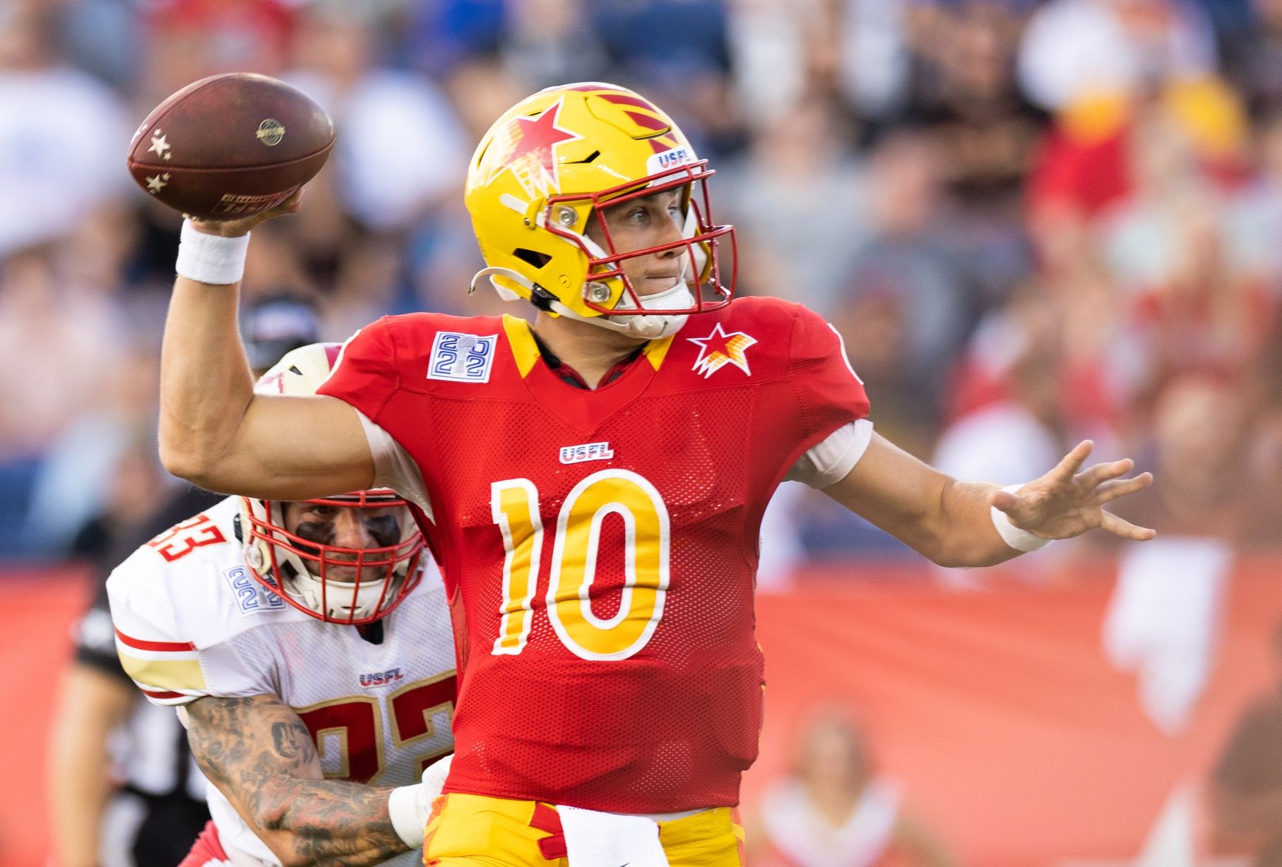 Philadelphia Stars quarterback Case Cookus (10) looks for a receiver under pressure from Birmingham Stallions inside linebacker Scooby Wright (33) during the first quarter at Tom Benson Hall of Fame Stadium.