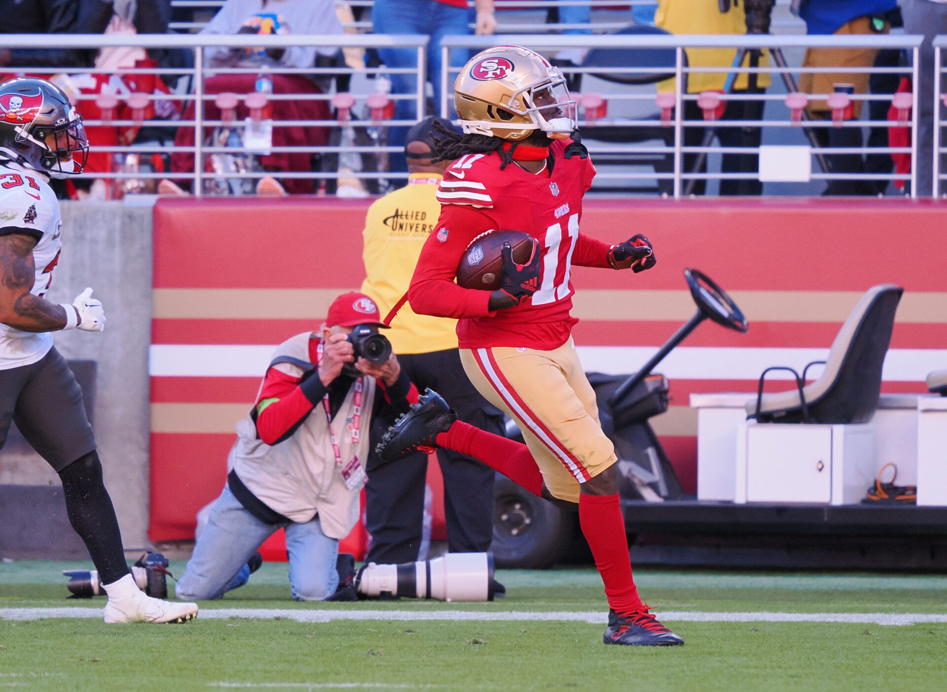 San Francisco 49ers wide receiver Brandon Aiyuk (11) runs after a catch for a 76-yard touchdown against the Tampa Bay Buccaneers during the third quarter at Levi's Stadium.