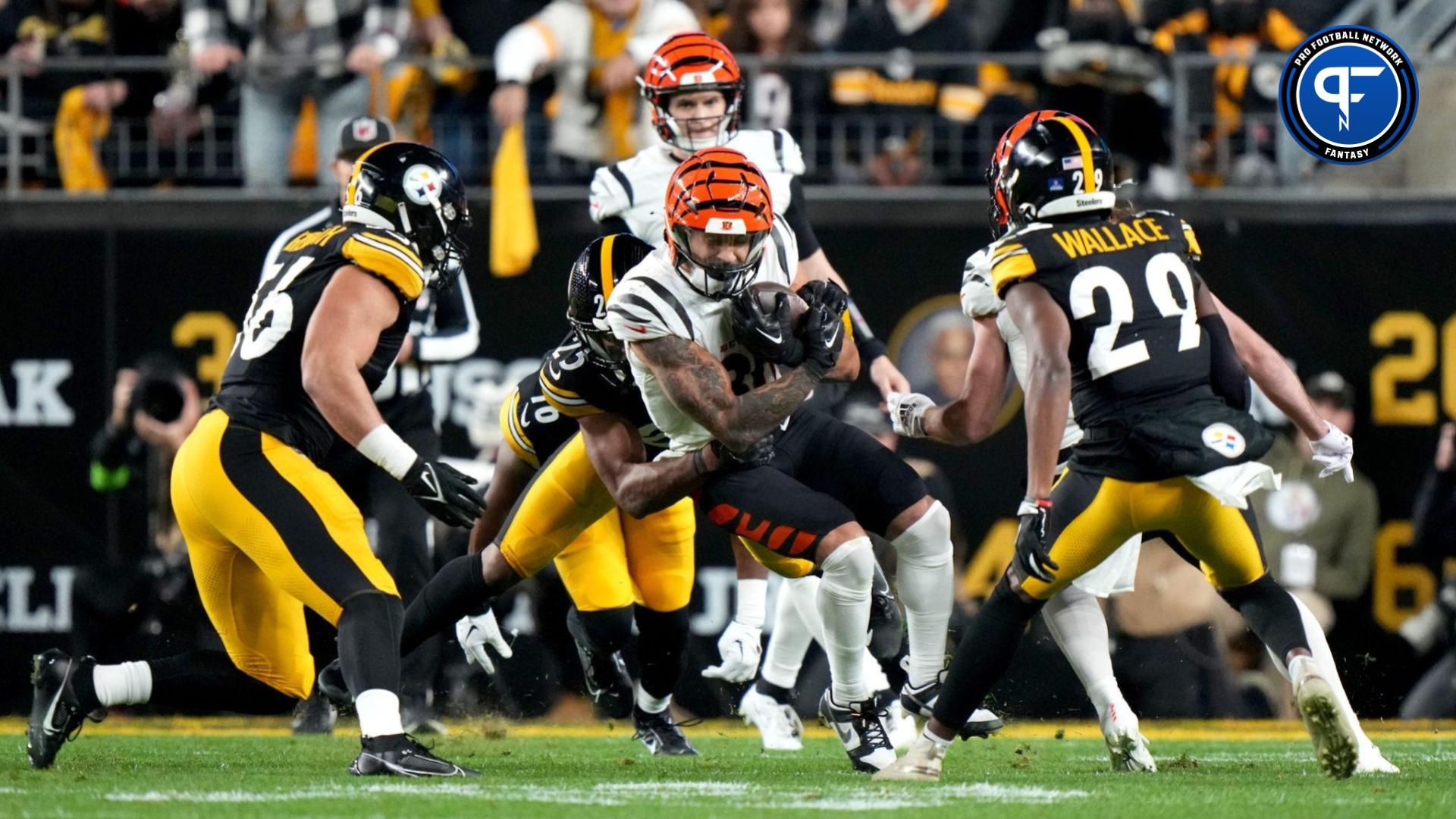 Cincinnati Bengals running back Chase Brown (30) is tackled by Pittsburgh Steelers safety Eric Rowe (25) in the second quarter during a Week 16 NFL football game between the Cincinnati Bengals and the Pittsburgh Steelersl, Saturday, Dec. 23, 2023, at Acrisure Stadium in Pittsburgh, Pa.
