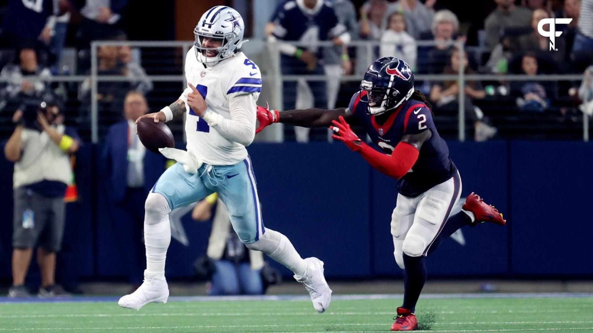 Dallas Cowboys quarterback Dak Prescott (4) runs away from Houston Texans cornerback Tavierre Thomas (2) during the second half at AT&T Stadium.