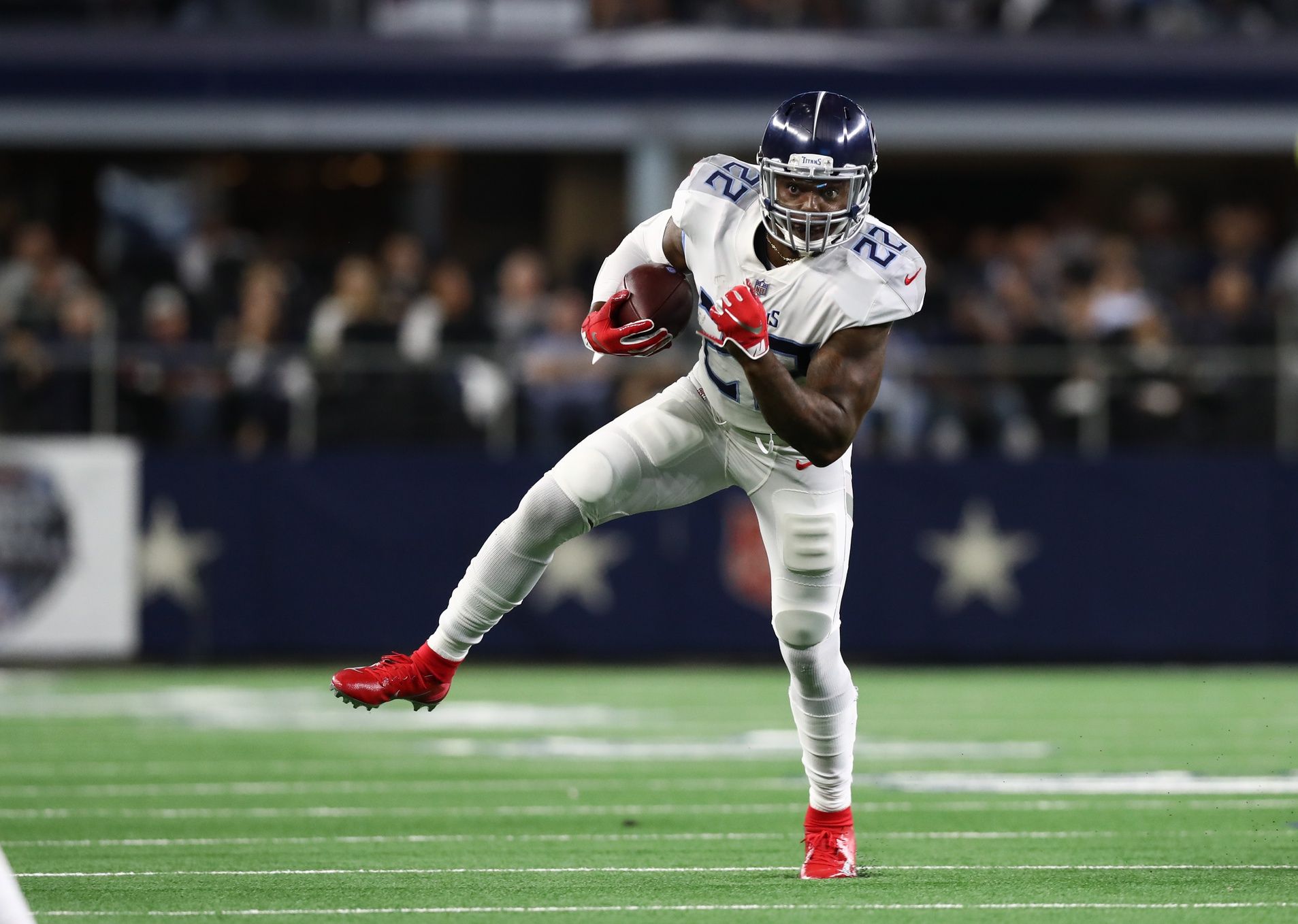Tennessee Titans running back Derrick Henry (22) runs with the ball against the Dallas Cowboys at AT&T Stadium.