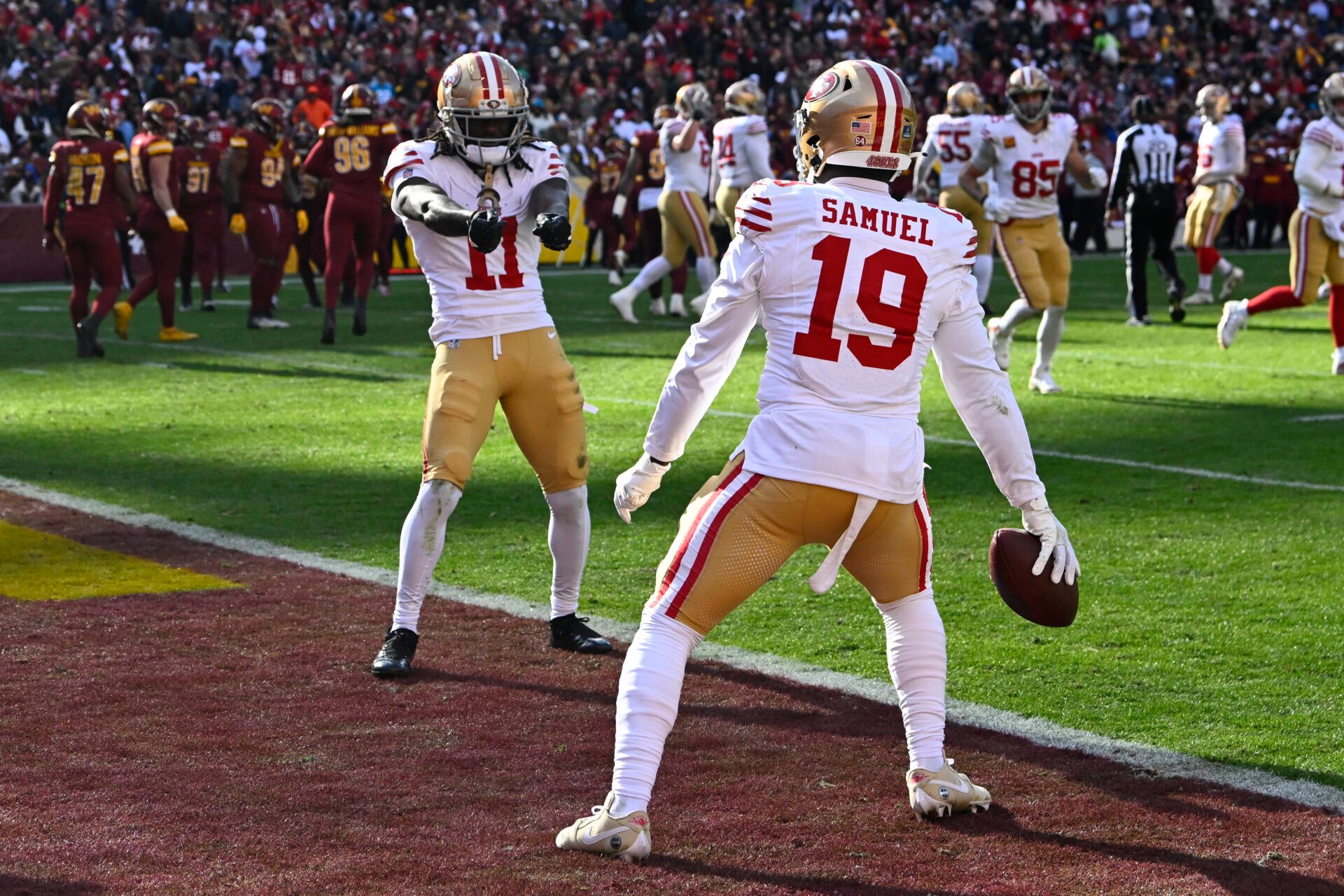 Dec 31, 2023; Landover, Maryland, USA; San Francisco 49ers wide receiver Deebo Samuel (19) celebrates with wide receiver Brandon Aiyuk (11) after scoring a touchdown against the Washington Commanders during the first half at FedExField. Mandatory Credit: Brad Mills-USA TODAY Sports