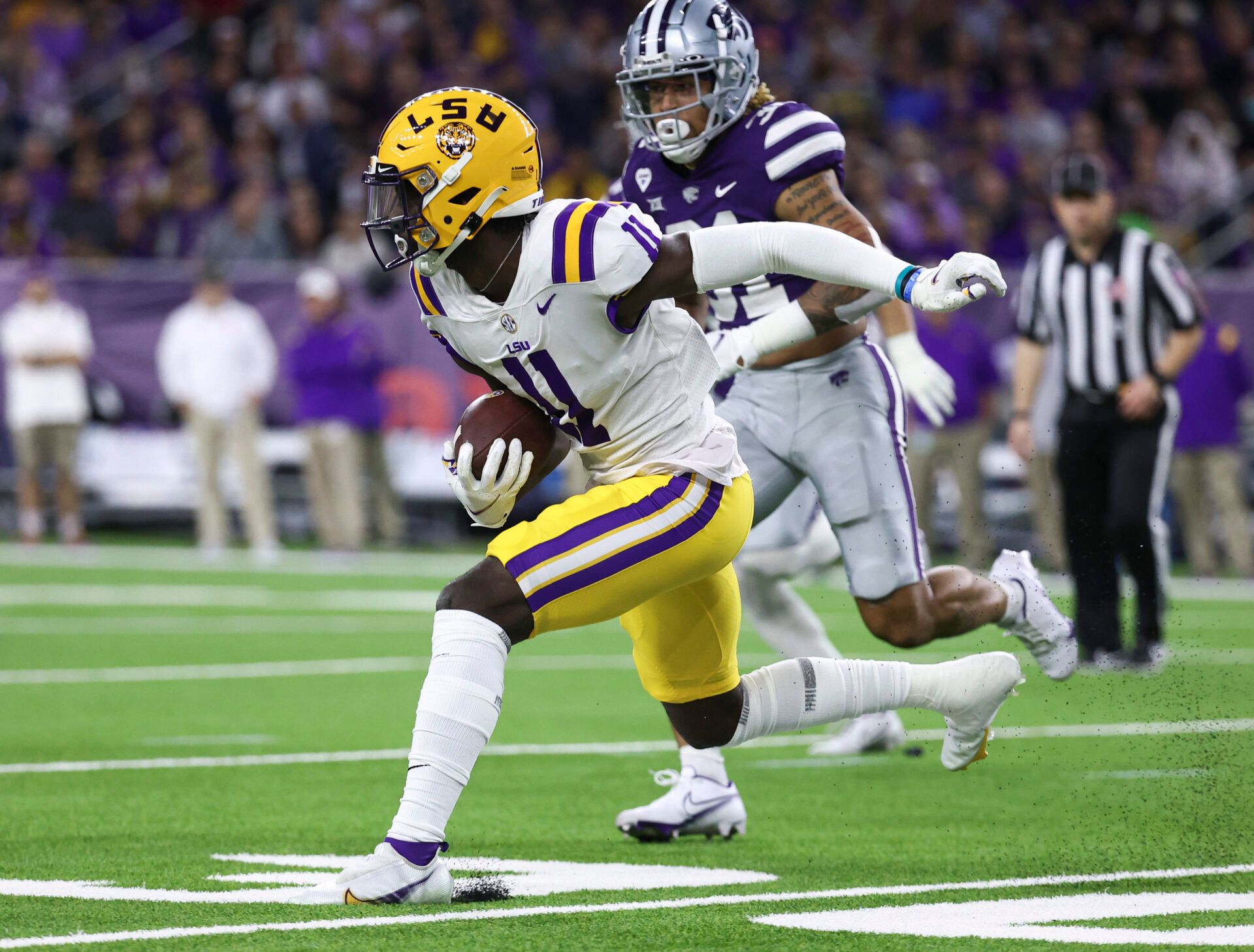 LSU Tigers wide receiver Brian Thomas Jr. (11) runs with the ball during the first quarter against the Kansas State Wildcats during the 2022 Texas Bowl at NRG Stadium.