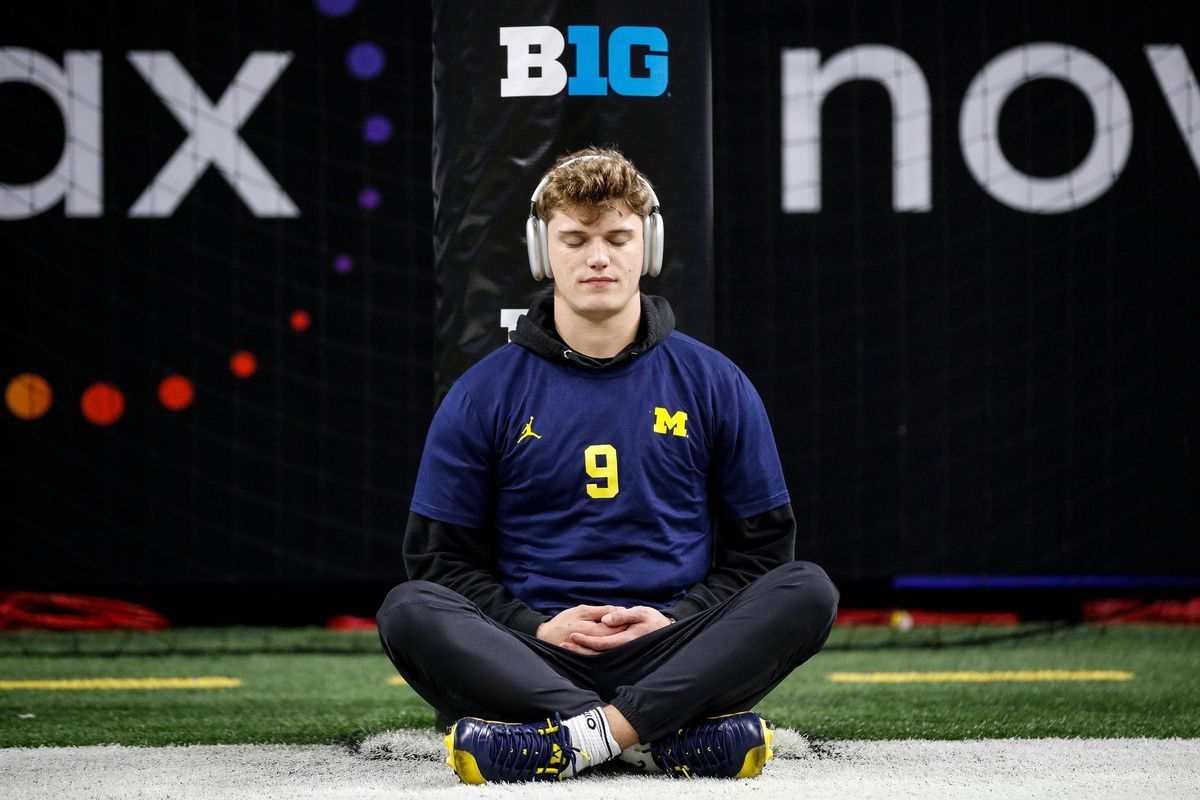 Michigan quarterback J.J. McCarthy meditates during warmups before the Big Ten championship game.