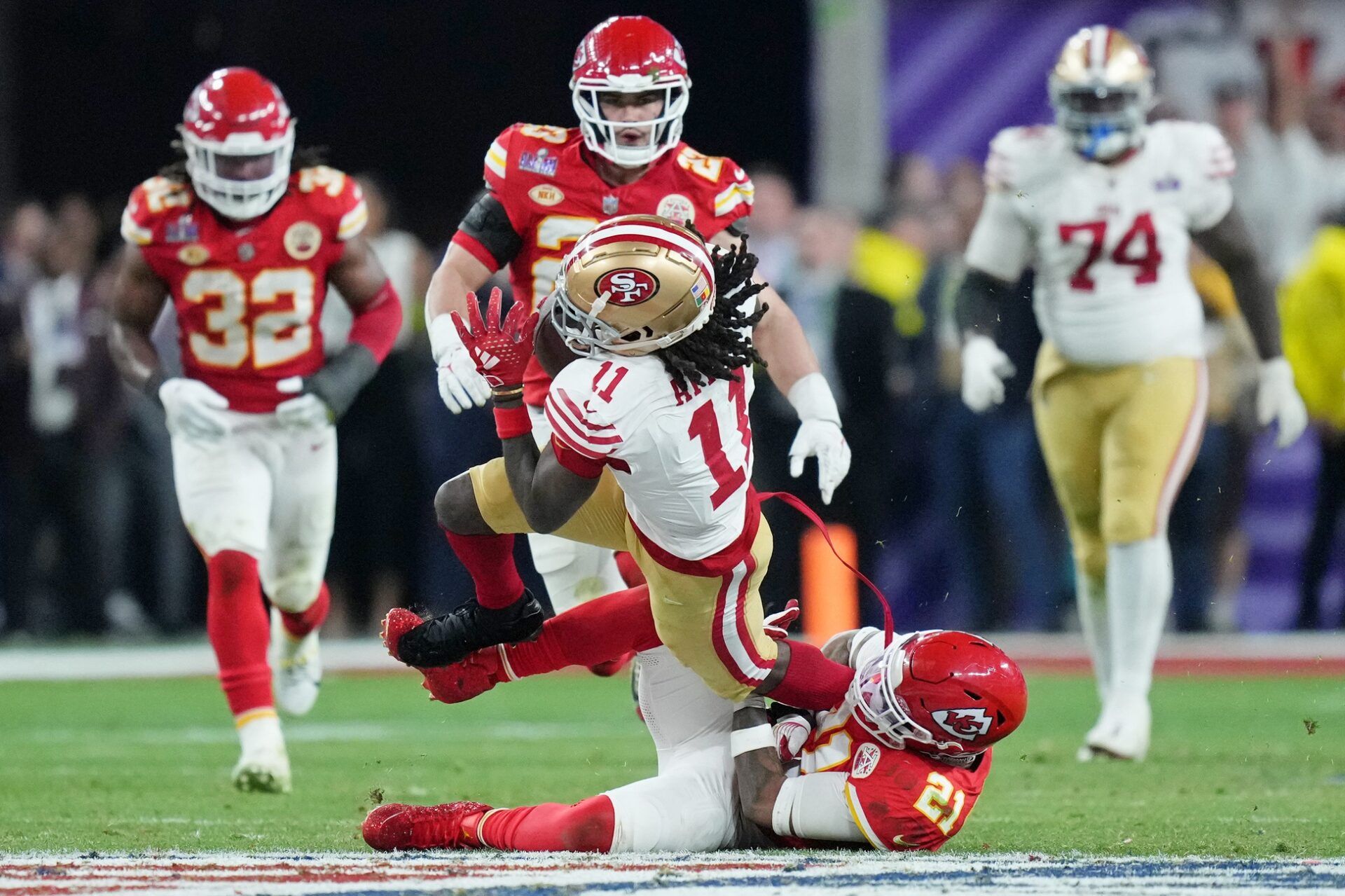 Kansas City Chiefs safety Mike Edwards (21) tackles San Francisco 49ers wide receiver Brandon Aiyuk (11) during overtime of Super Bowl LVIII at Allegiant Stadium.