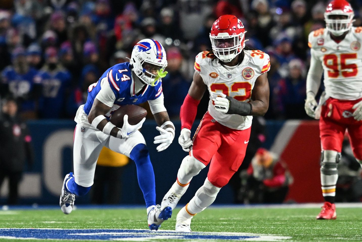 Buffalo Bills wide receiver Stefon Diggs (14) makes a catch against Kansas City Chiefs linebacker Nick Bolton (32) in the first half of the 2024 AFC divisional round game at Highmark Stadium.