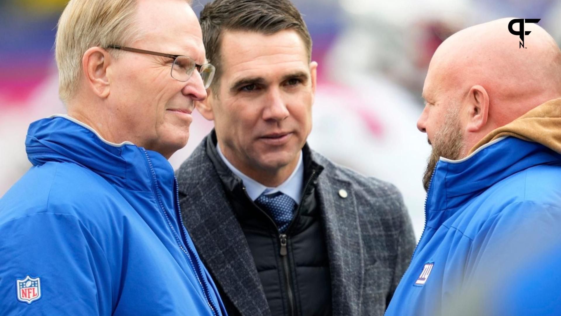 New York Giants head coach Brian Daboll (right) talks to the team's president, John Mara (left) and GM Joe Schoen (middle).