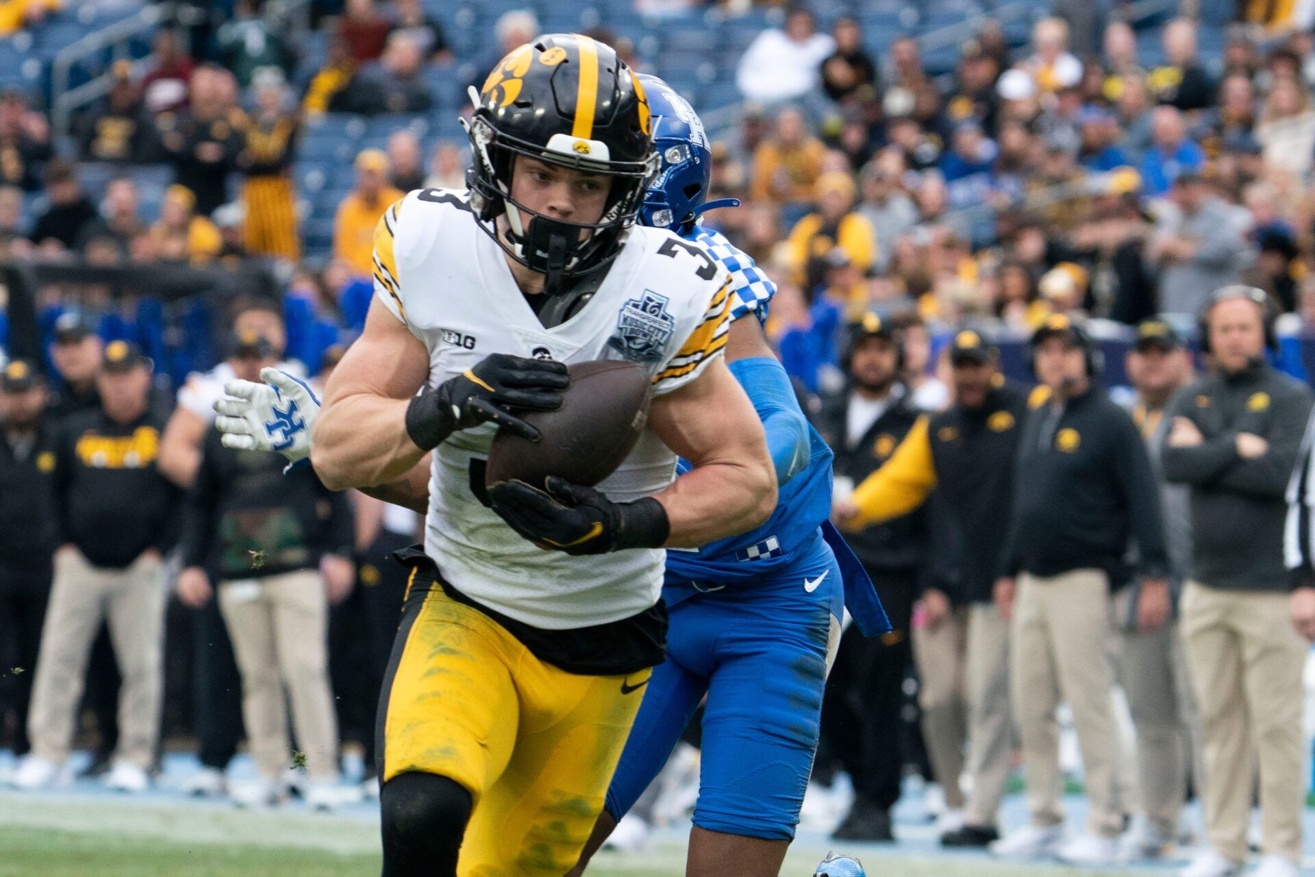 Iowa defensive back Cooper DeJean (3) pulls in an interception for a touchdown over Kentucky wide receiver Barion Brown (2) during the second quarter of the TransPerfect Music City Bowl at Nissan Stadium Saturday, Dec. 31, 2022, in Nashville, Tenn.