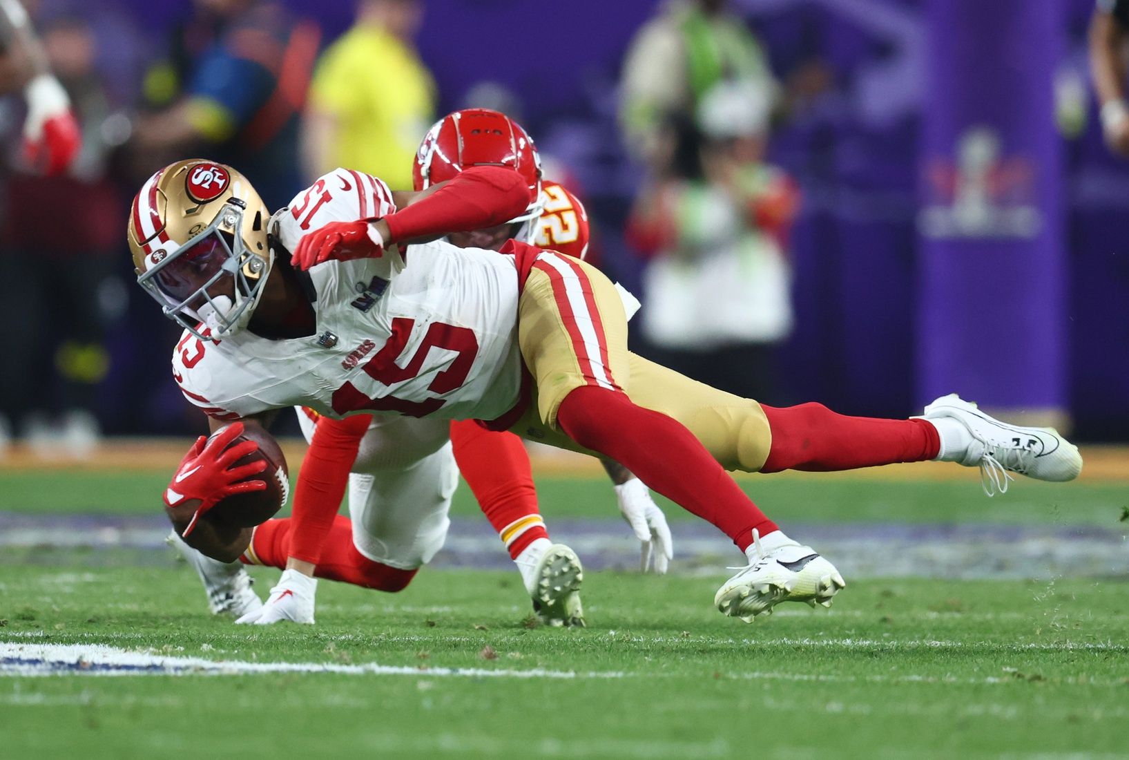 San Francisco 49ers WR Jauan Jennings (15) dives for more yardage against the Kansas City Chiefs in the Super Bowl.