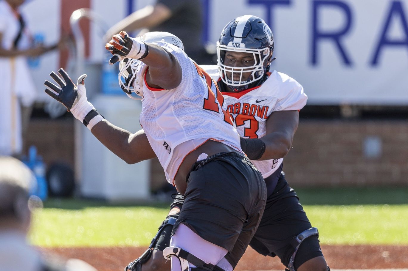 American offensive lineman Christian Haynes of Uconn (63) faces off against American offensive lineman Christian Jones of Texas (70) during practice for the American team at Hancock Whitney Stadium.