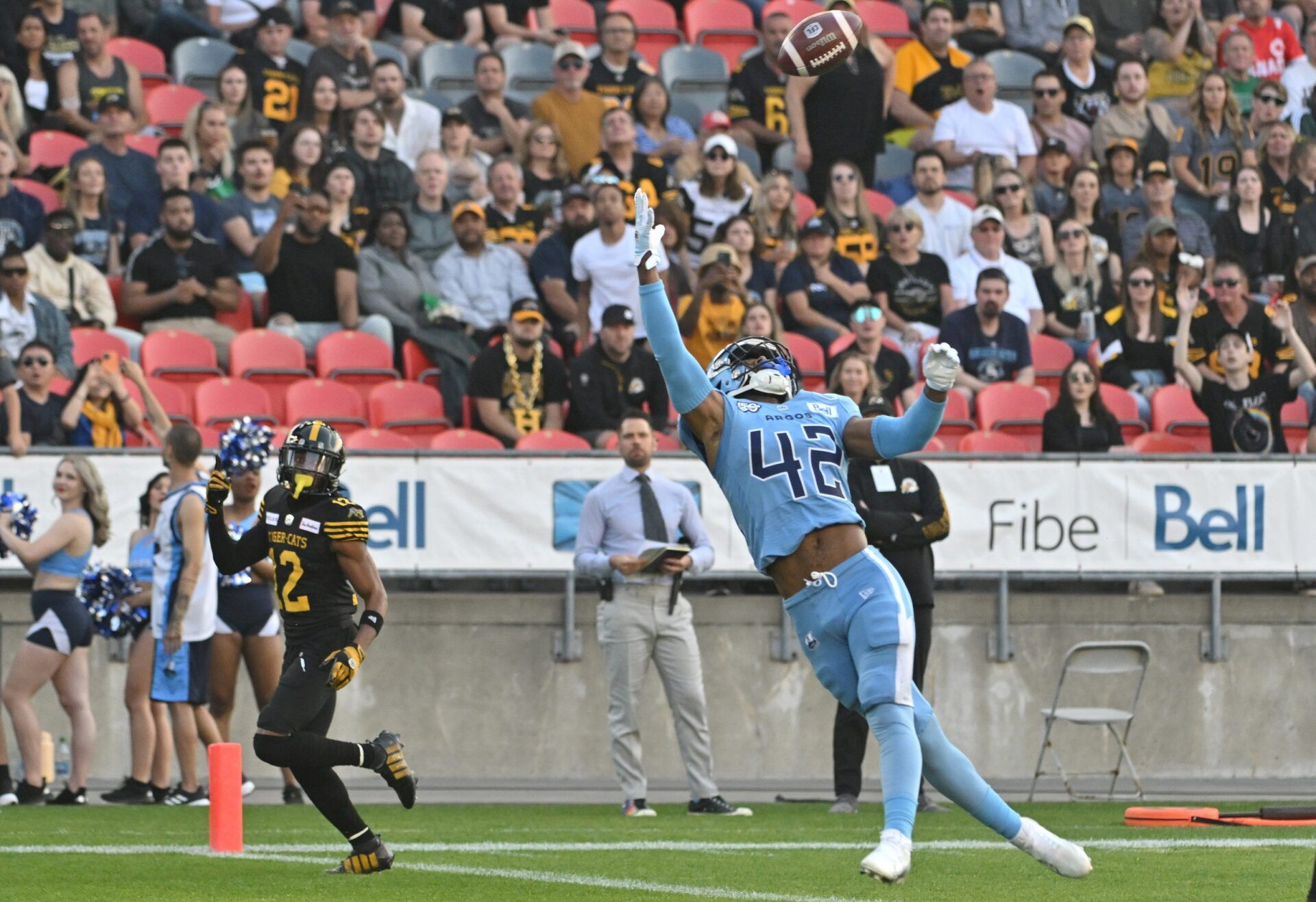 Toronto Argonauts defensive back Qwan'tez Stiggers (42) reaches up to intercept a pass intended for Hamilton Tiger-Cats wide receiver Tim White (12) in the first quarter at BMO Field.