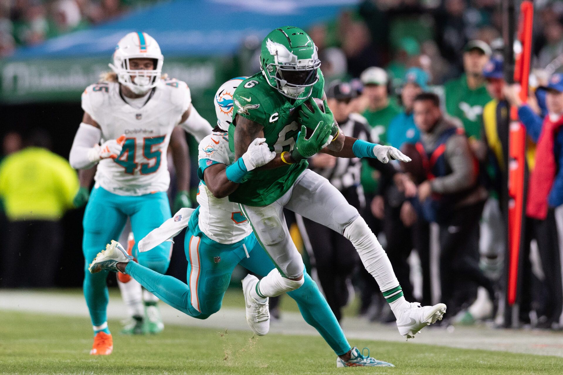 Philadelphia Eagles wide receiver DeVonta Smith (6) runs with the ball after a catch in front of Miami Dolphins cornerback Eli Apple (33) during the third quarter at Lincoln Financial Field.