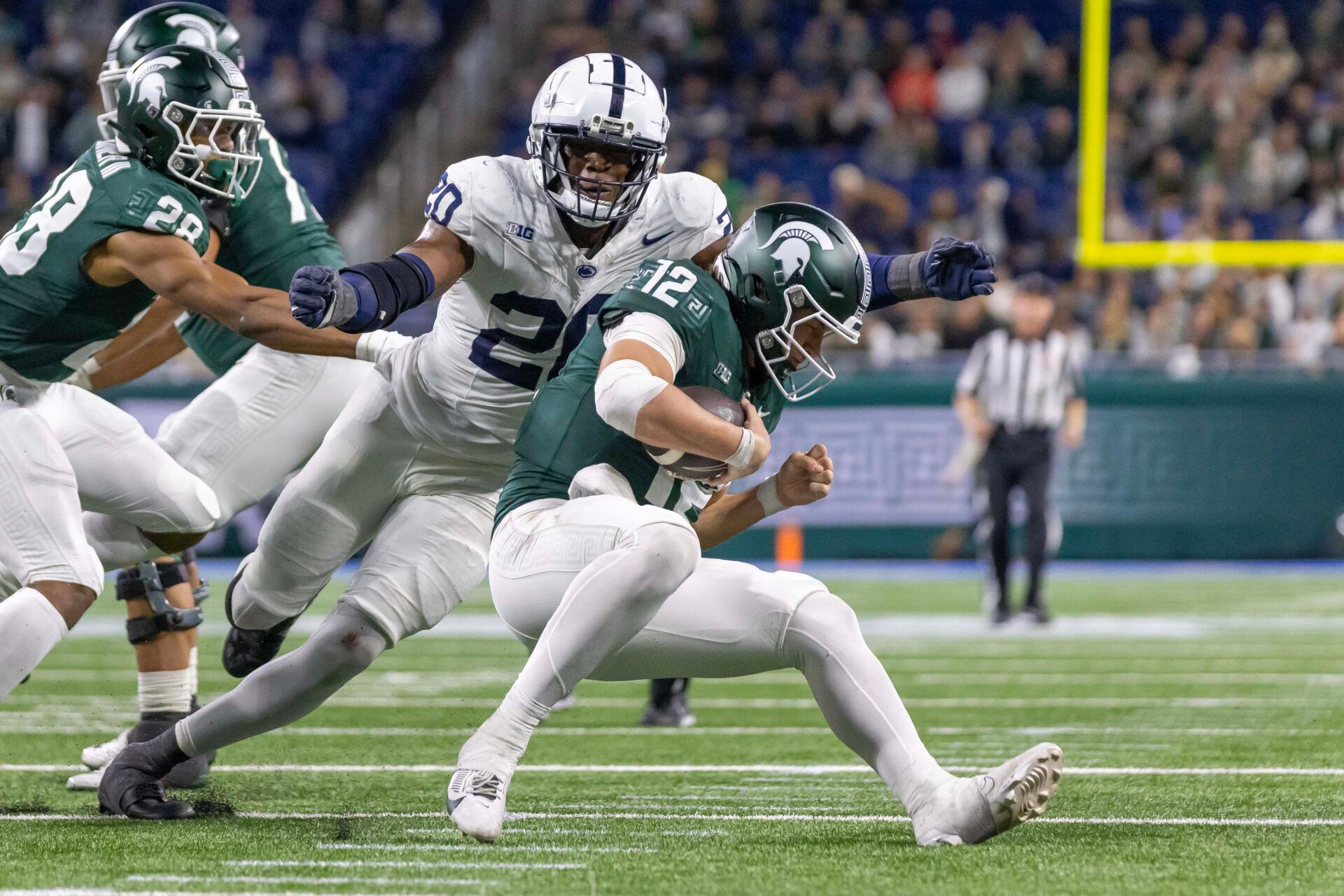 Penn State Nittany Lions defensive end Adisa Isaac (20) pressures and sacks Michigan State Spartans quarterback Katin Houser (12) during the second half at Ford Field.