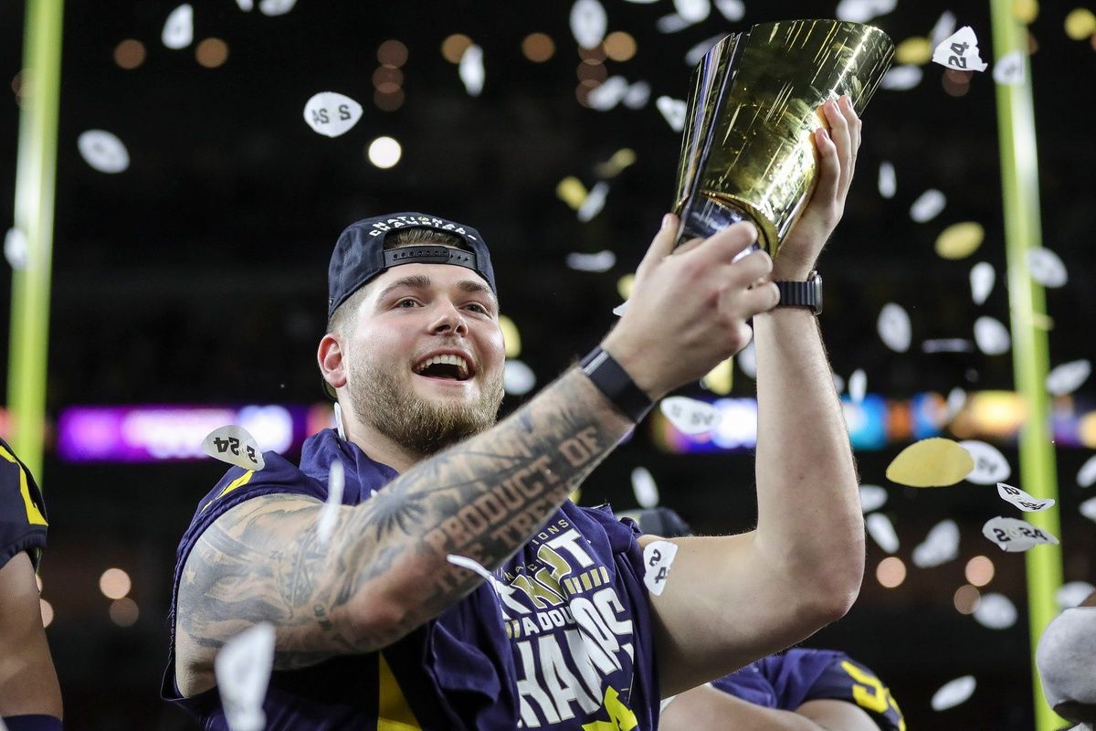 Michigan offensive lineman Zak Zinter celebrate 34-13 win over Washington at the national championship game at NRG Stadium.