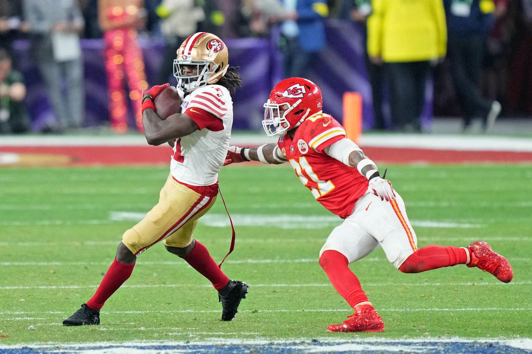 San Francisco 49ers wide receiver Brandon Aiyuk (11) makes a catch against Kansas City Chiefs safety Mike Edwards (21) during overtime of Super Bowl LVIII at Allegiant Stadium.