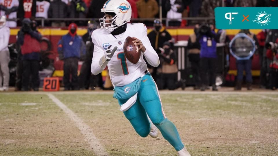 Miami Dolphins quarterback Tua Tagovailoa (1) moves out to pass against the Kansas City Chiefs during the second half of the 2024 AFC wild card game at GEHA Field at Arrowhead Stadium.