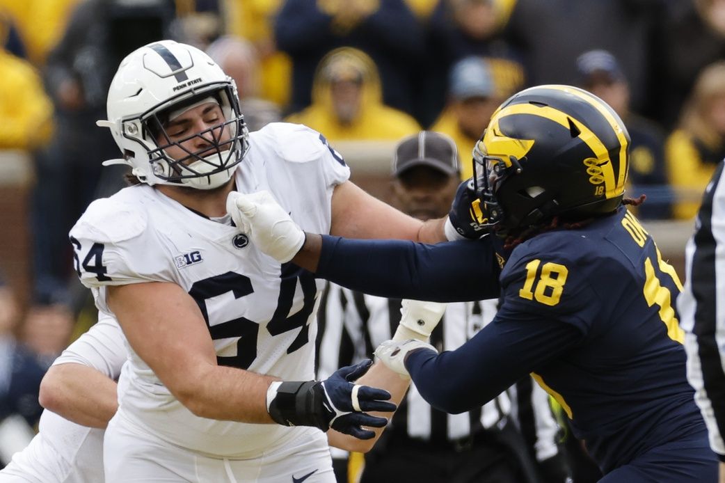 Penn State Nittany Lions offensive lineman Hunter Nourzad (64) blocks Michigan Wolverines linebacker Eyabi Okie (18) in the second half at Michigan Stadium.