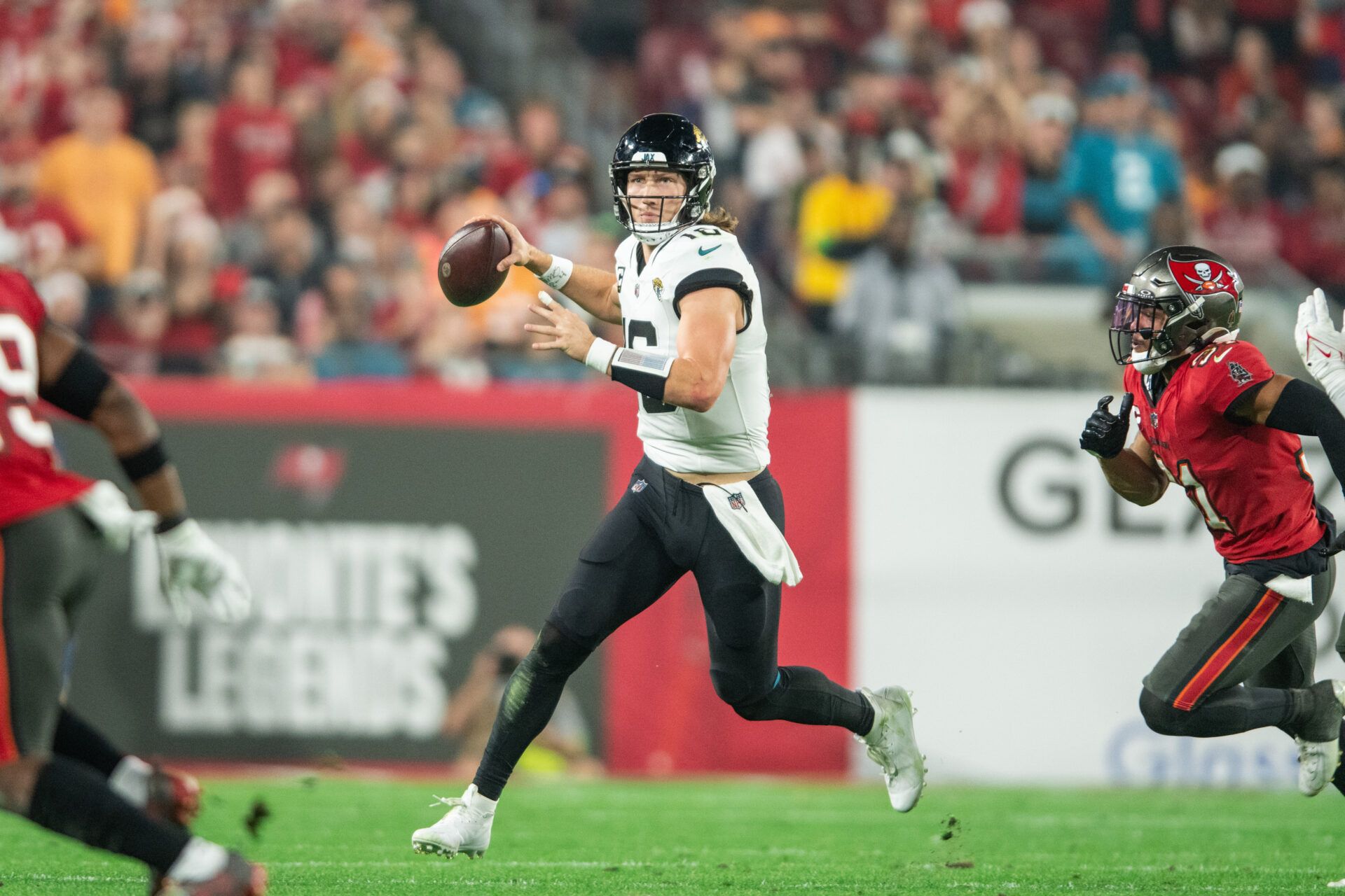 Jacksonville Jaguars quarterback Trevor Lawrence (16) runs the ball against the Tampa Bay Buccaneers in the third quarter at Raymond James Stadium.