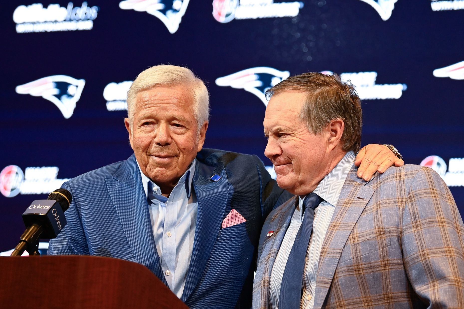 New England Patriots former head coach Bill Belichick (right) embraces Patriots owner Robert Kraft (left) during a press conference.