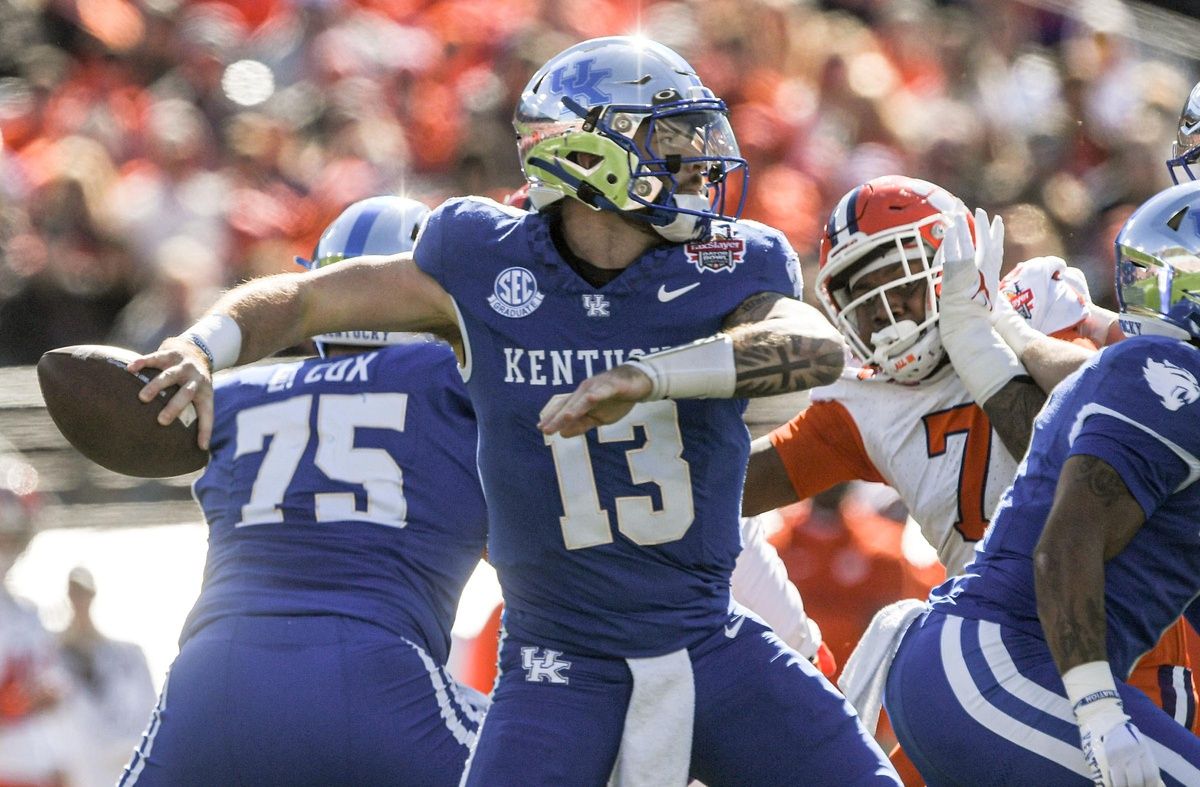 Kentucky quarterback Devin Leary (13) passes near Clemson defensive end Justin Mascoll (7) during the first quarter of the TaxSlayer Gator Bowl at EverBank Stadium in Jacksonville, Florida, Friday, December 29, 2023.