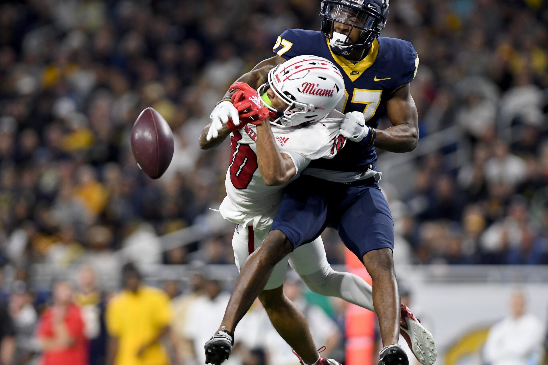 Toledo Rockets cornerback Quinyon Mitchell (27) breaks up a pass intended for Miami (OH) Redhawks wide receiver Gage Larvadain (10) in the third quarter at Ford Field.