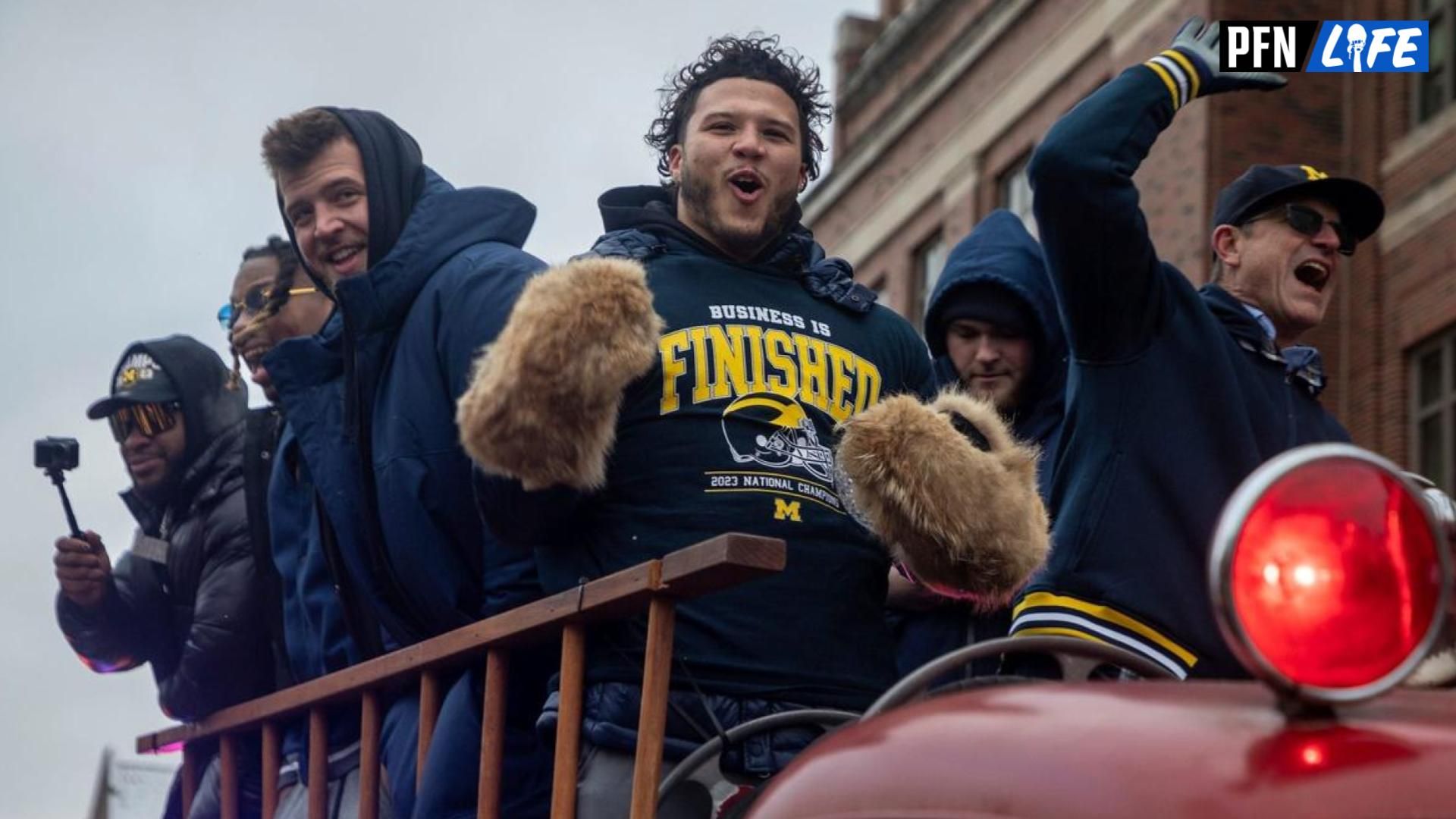 Jan. 13, 2024: Michigan players Trevor Keegan (left) and Blake Corum, as well as Jim Harbaugh, celebrate with the fans during a national championship celebration parade at the University of Michigan campus in Ann Arbor.