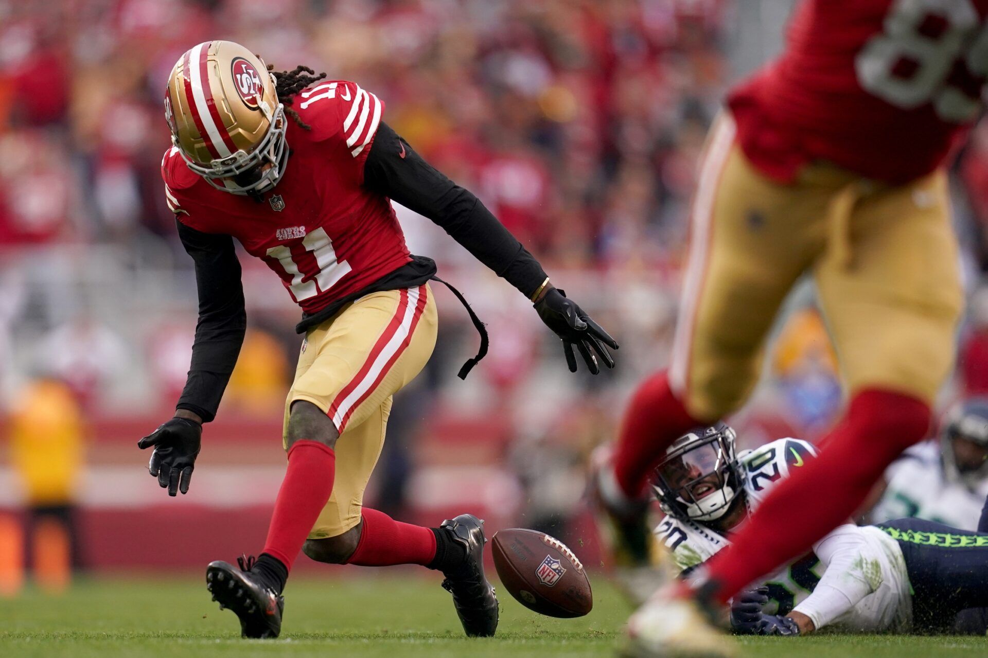 San Francisco 49ers wide receiver Brandon Aiyuk (11) fumbles the ball in front of Seattle Seahawks safety Julian Love (20) in the fourth quarter at Levi's Stadium.